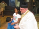 Fr Jason and children at the end of Mass